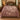 Pheasant Hedgerow Harvest botanical woven blanket spread across a bed