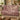 Pheasant Hedgerow Harvest woven blanket draped over a sofa or armchair