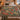 Pomegranate Hoopoes botanical woven blanket spread across a bed