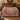 Pomegranate Vine Courtyard botanical woven blanket spread across a bed