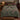 Raven Sloe Wood botanical woven blanket spread across a bed
