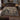 Raven Sloe Wood botanical woven blanket spread across a bed