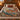Rowan Waxwings botanical woven blanket spread across a bed