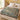 The Low Trellis botanical woven blanket spread across a bed