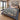 The Sea Holly Mound botanical woven blanket spread across a bed