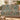 Thistle Copse woven blanket draped over a sofa or armchair