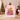 Woman holding a personalized Pink Grinch Ribbon Christmas fleece blanket with custom family name on the gift ribbon