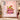 Pink Grinch Ribbon Christmas fleece blanket displayed on a wall