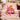 Pink Grinch Ribbon Christmas fleece throw draped over a sofa
