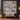 Personalized blue reading room quilt hung on a wall with sample family name The Everly Family