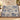 Personalized The Unhurried Chapter blue toile woven blanket draped over an ivory sofa