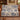 Personalized The Unhurried Chapter blue toile woven blanket draped over a cognac leather sofa