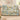 Dad's Brightest Stars woven blanket with Lily, Mason and Sophie on blue-and-ivory ornamental star and floral artwork, spread across an ivory sofa viewed from the front.