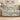 Dad's Brightest Stars woven blanket with Lily, Mason and Sophie on blue-and-ivory ornamental star and floral artwork, spread across a taupe sofa viewed from the front.