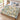 Dad's Brightest Stars woven blanket with Lily, Mason and Sophie on blue-and-ivory ornamental star and floral artwork, laid across a modern bed.
