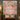 Personalized Sweater Corgi Garden quilt hung on a wall with sample name Rosie