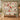 Personalized Christmas Golf Garden quilt with sample family name hung on a wall above a bench with 2 matching pillowcases