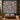 Personalized Ornamented Winter Stags quilt with sample family name hung on a wall above a bench with 2 matching pillowcases