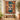The Garden You Left Behind pet memorial woven blanket with a Schnauzer photo and the name Bella, hung by a sunny window