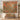 Tupelo Coral Canopy quilt hung on a wall above a bench with 2 matching pillowcases, autumn forest scene