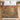Tupelo Coral Canopy woodland woven blanket spread across a bed with white pillows