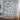 Yuletide Keepsake Patchwork woven blanket in blue hung as a Christmas wall tapestry with sample family name The Thompsons