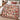 Yuletide Keepsake Patchwork woven blanket in pink spread across a bed, vintage Christmas patchwork throw