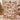 Yuletide Keepsake Patchwork woven blanket in pink held up in a festive living room
