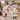 Couple holding a personalized Snowfall Paper Village Christmas woven blanket with sample family name The Thompsons