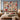 Snowfall Paper Village Christmas woven blanket hung as a wall tapestry with sample family name