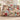 Snowfall Paper Village Christmas woven blanket draped over a sofa, paper houses and plaid patchwork