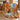 Woodland mallard fleece throw draped over a chair by a stone fireplace