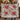 Couple holding a personalized Crimson Solstice poinsettia Christmas woven blanket with sample family name The Thompsons