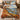 Personalized Whitetail Buck Driftless Bluffs quilt hung on a wooden rod above a bench with 2 pillow shams and sample family name