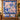 Swallow Iris Ribbon Ballet quilt hung on a wall with sample family name The Lancaster Family above a bench with 2 matching pillowcases