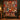 Red Lily Garden Nativity Christmas quilt hung on a wall above a bench with 2 matching pillowcases