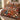 Red Lily Garden Nativity Christmas quilt bedding set with 2 matching pillowcases on a bed beside a window