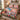 Nutcracker Dream Ballet Christmas quilt bedding set with 2 matching pillowcases on a bed beside a window