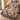 Christmas Carousel Garden quilt bedding set with 2 matching pillowcases on a bed beside a window