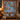 Partridge Pear Christmas quilt hung on a wall with sample family name The Ainsworth Family above a bench with 2 matching pillowcases