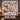 Christmas Dogs Poinsettia quilt hung on a wall with sample family name The Wakefield Family above a bench with 2 matching pillowcases