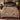 Clouded leopard woven blanket with hornbill and pink orchids spread across a bed