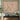 Blue magpie bamboo blossom woven blanket hung as a wall tapestry above a lacquer console