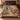 Raccoon Pawpaw Curio Study woven blanket spread across a bed in a cozy bedroom