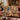 Raccoon Pawpaw Curio Study woven blanket draped over a sofa in a living room