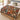 Red Lily Garden Nativity woven blanket spread across a bed in a Christmas bedroom