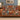 Red Lily Garden Nativity woven blanket draped over a sofa in a holiday living room