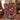 Couple holding a personalized Red Navy Christmas Pudding woven blanket with custom names woven in