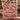 Couple holding a personalized Red Poinsettia Legend Pattern woven blanket with custom family name