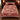 Red Poinsettia Legend Pattern woven blanket with custom family name spread on a bed